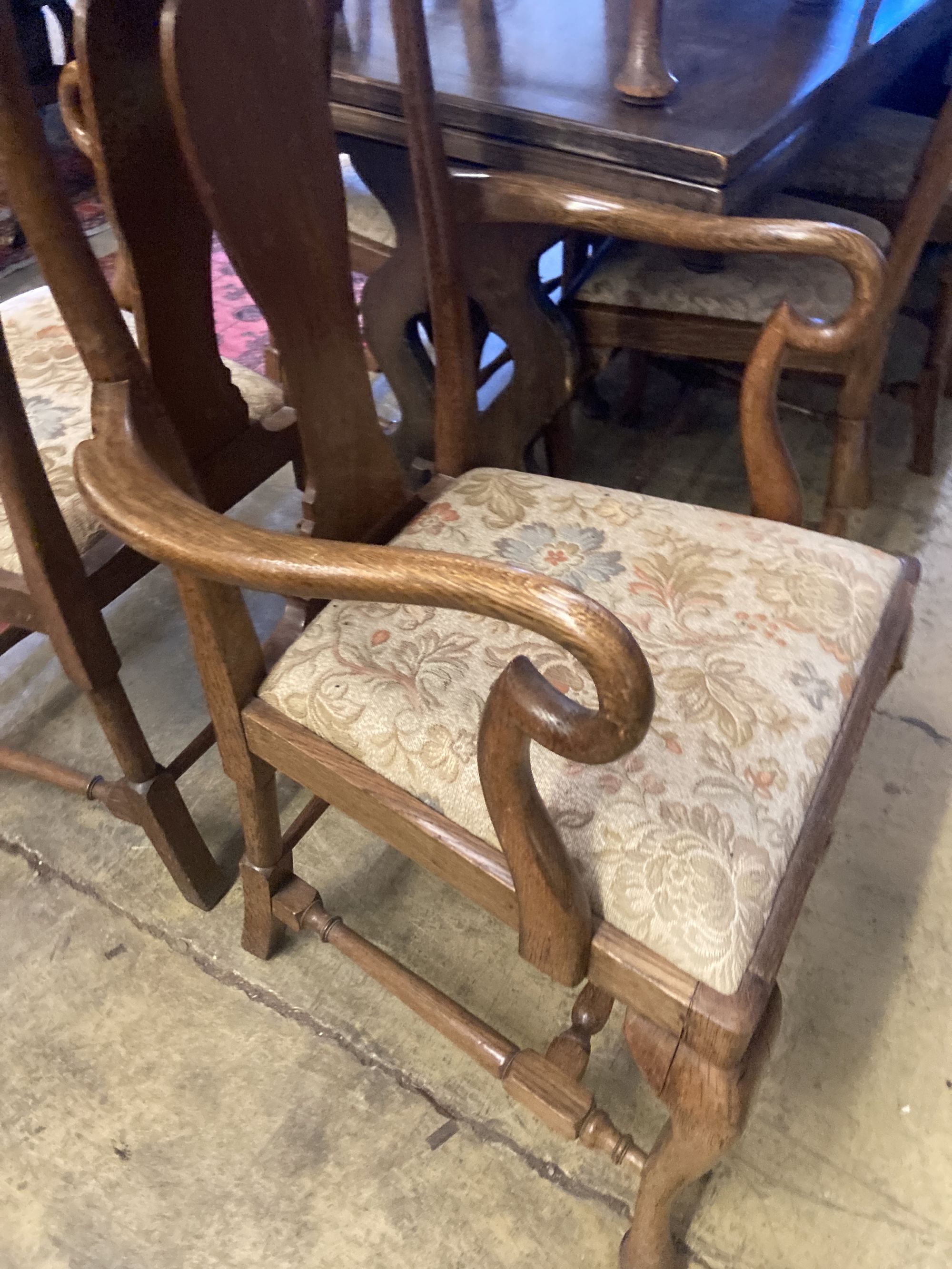 A set of eight 1920s oak Queen Anne-style dining chairs, two with arms